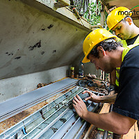Workers examining core samples at drilling site